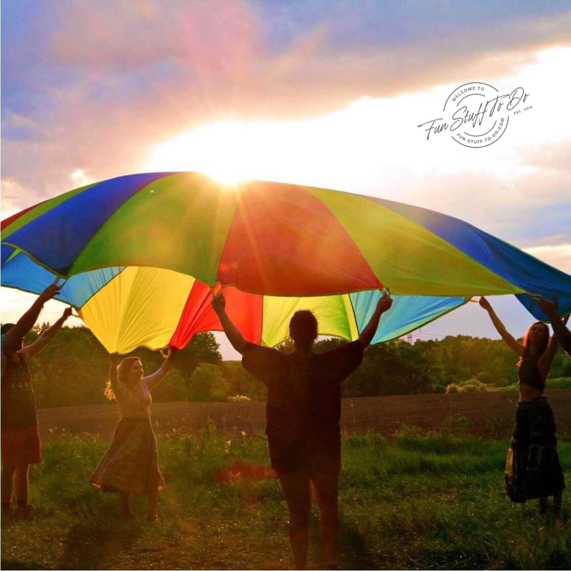 A group of people playing fun parachute games outdoors
